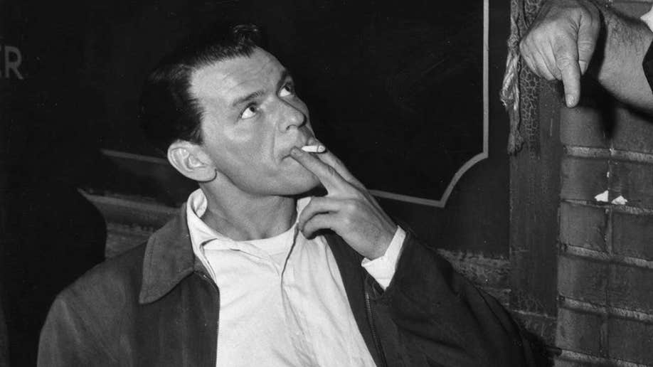 Frank Sinatra smoking a cigarette in 1955. 