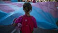 A girl holds the Transgender Pride flag during the pride march held in one of the most important streets of Madrid, Spain. - Fox News