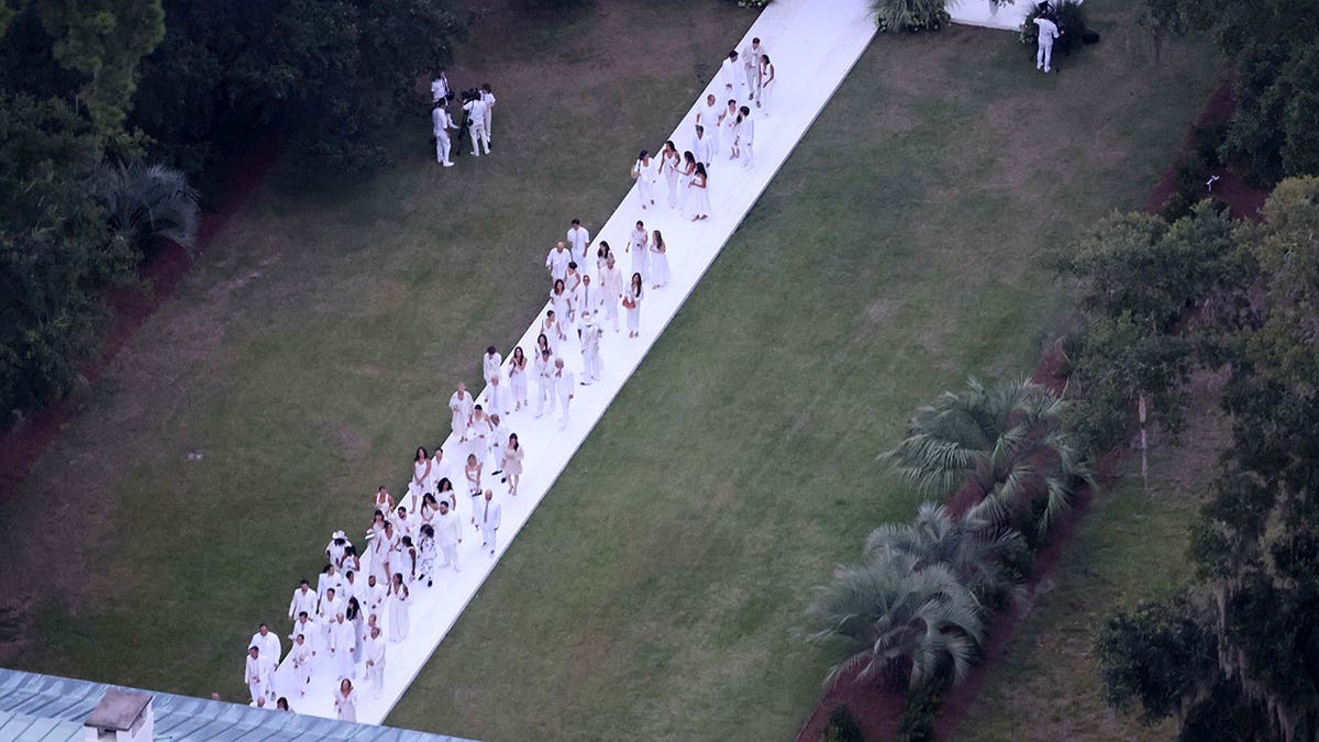 Guests walk down aisle