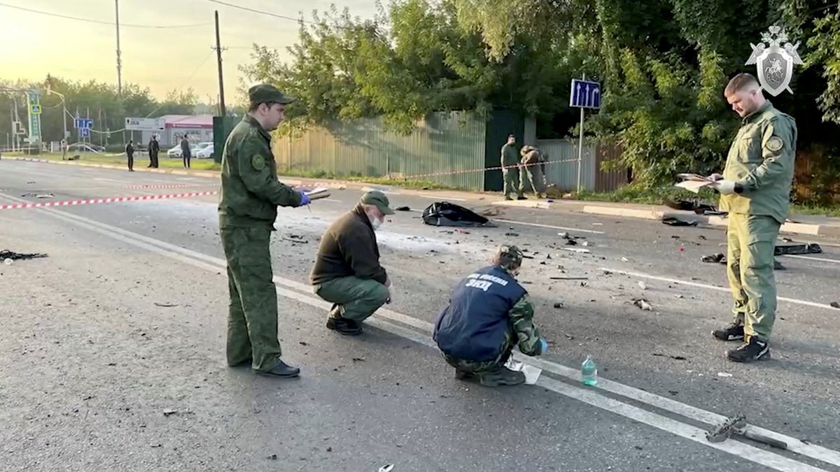 Russian investigators examine the area around Daria Dugina's car explosion