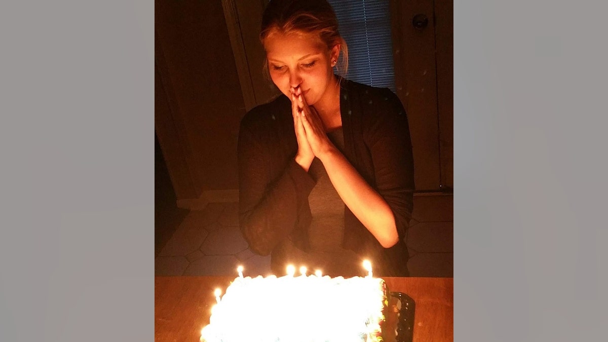 Taylor Pomaski blows out birthday candles