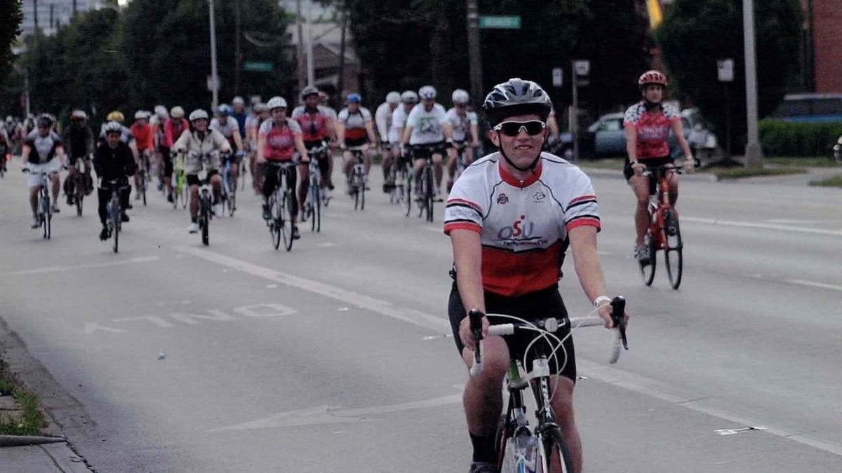Mason Fisher biking in a charity race