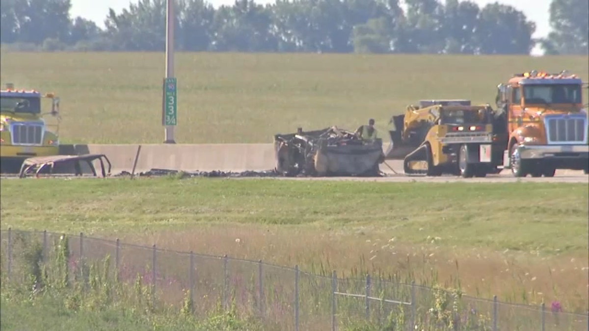 A car and van are seen burned on the side of an Illinois interstate