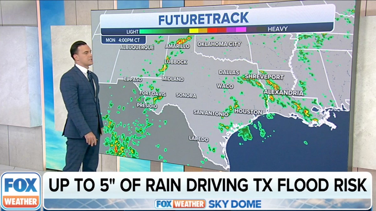 A weather person in front of a map showing rain in Texas