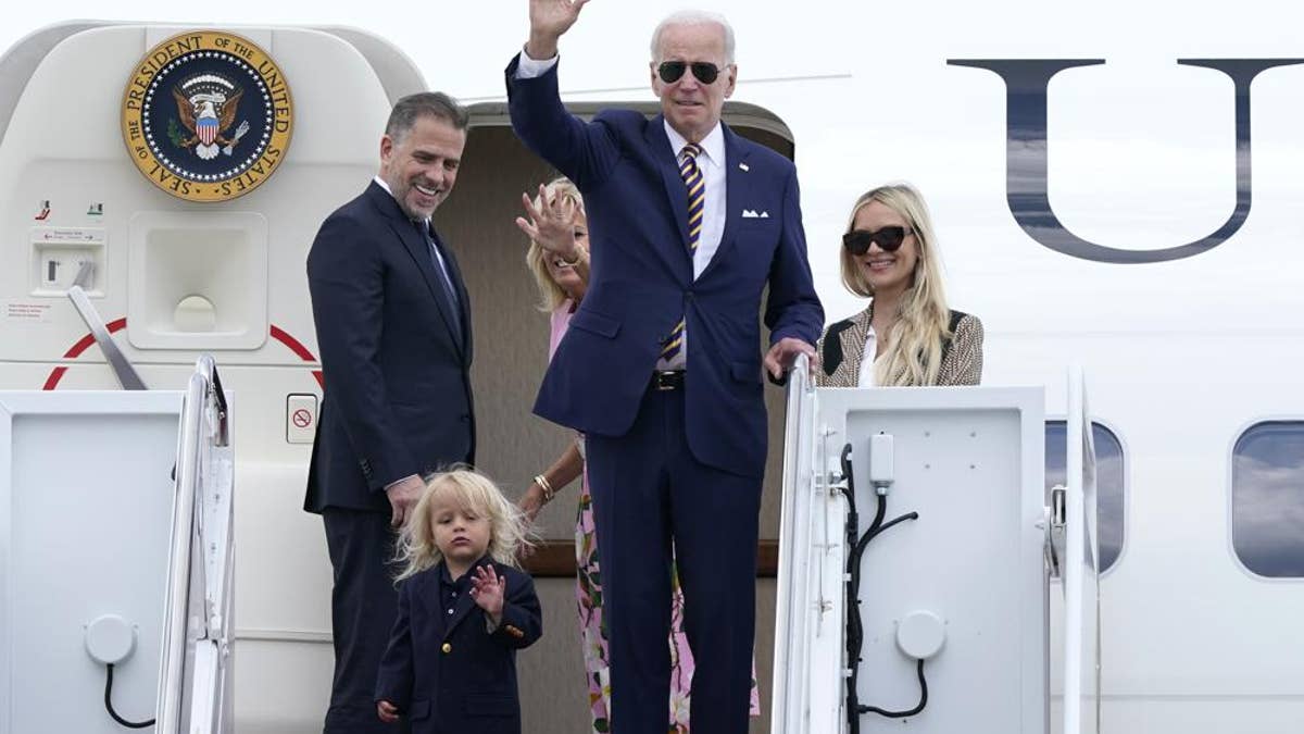 President Joe Biden waves to reporters