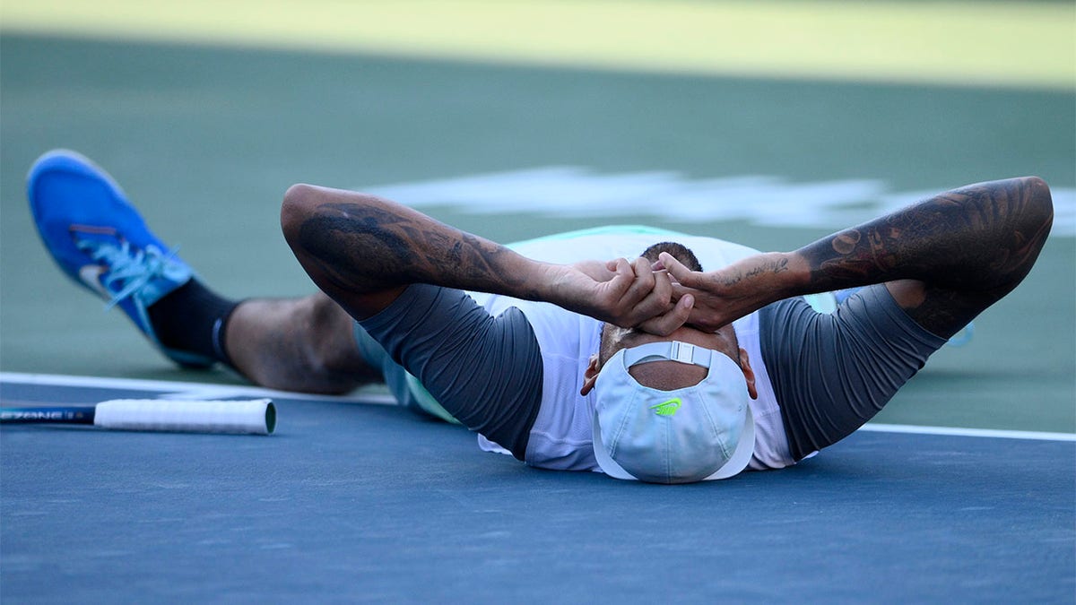 Nick Kyrgios lays down on court