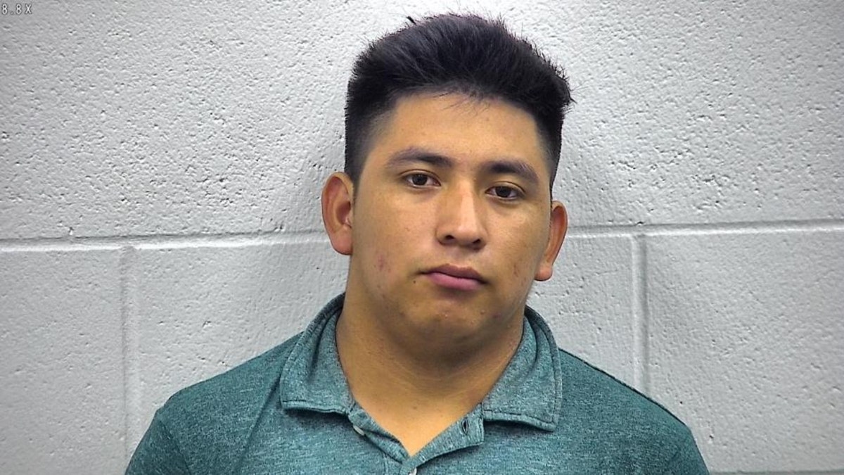 Robin Velasquez-Perez mugshot in front of a white brick wall