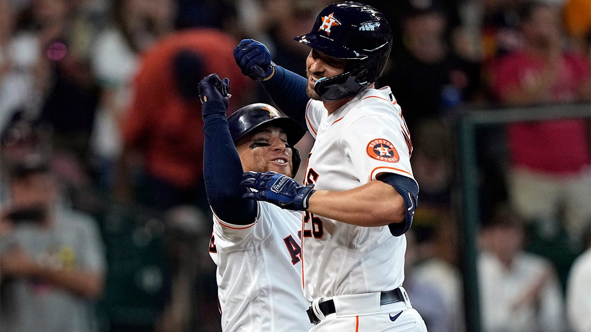 Trey Mancini celebrates with Christian Vazquez