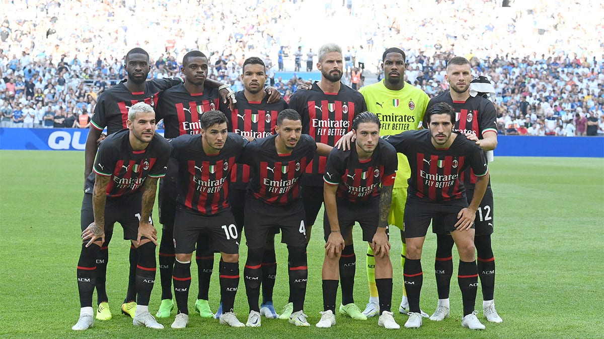Players of Milan pose