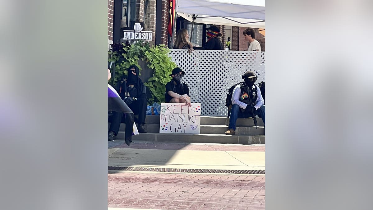 Protester outside Anderson Distillery & Grill in Roanoke, Texas