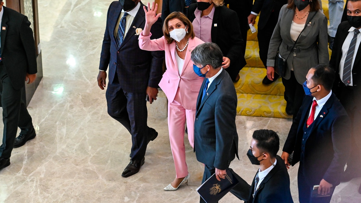 Nancy Pelosi wearing a pink suit in Malaysia