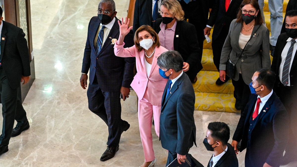 Nancy Pelosi wearing a pink suit in Malaysia