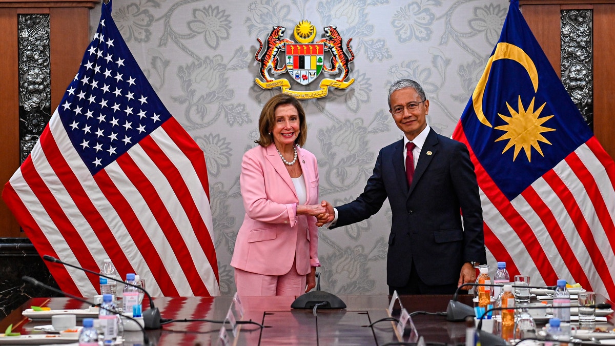 Nancy Pelosi shakes hands with Malaysia Parliament speaker Azhar Azizan Harun