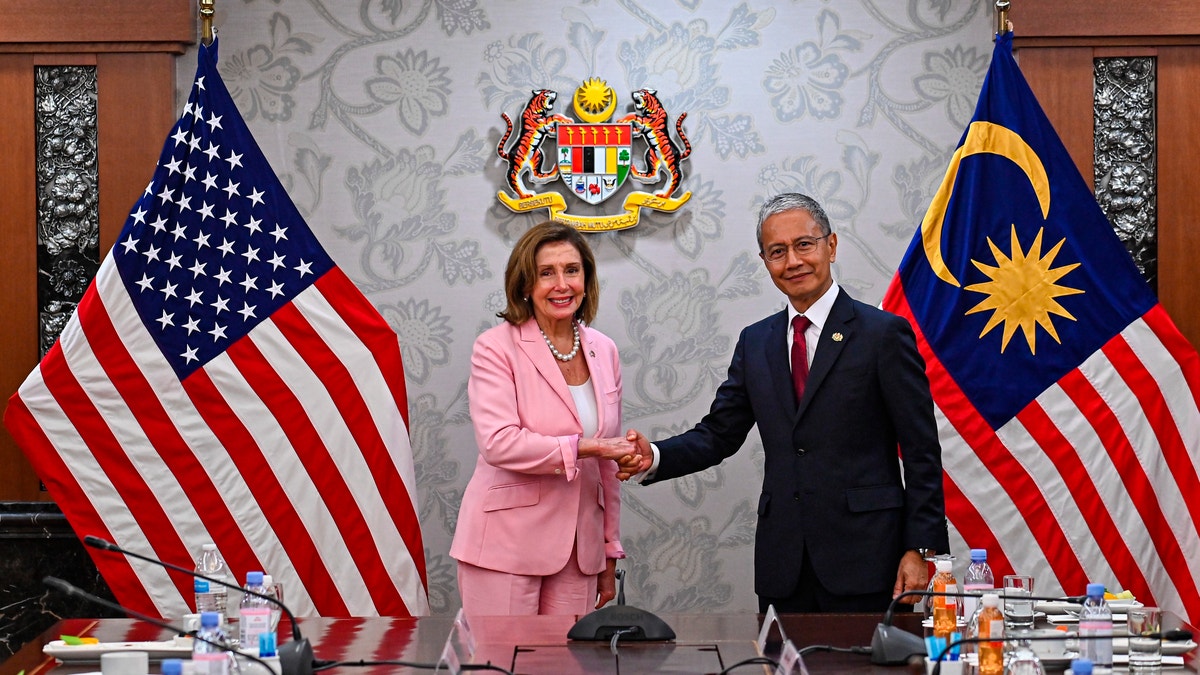 Nancy Pelosi shakes hands with Malaysia Parliament speaker Azhar Azizan Harun