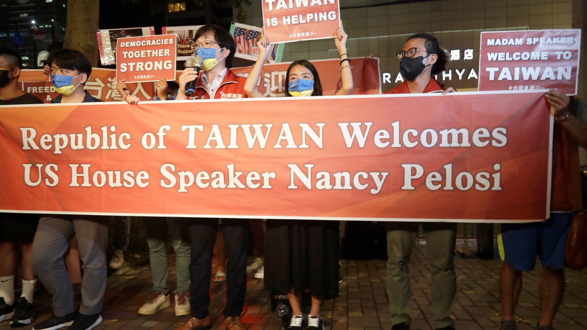 Supporters hold banner to welcome Nancy Pelosi visit to Taiwan