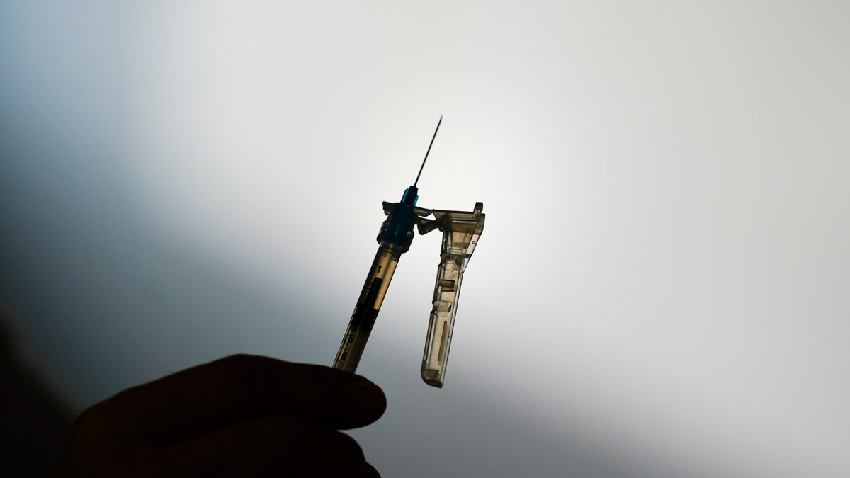 A syringe is prepared at a clinic 