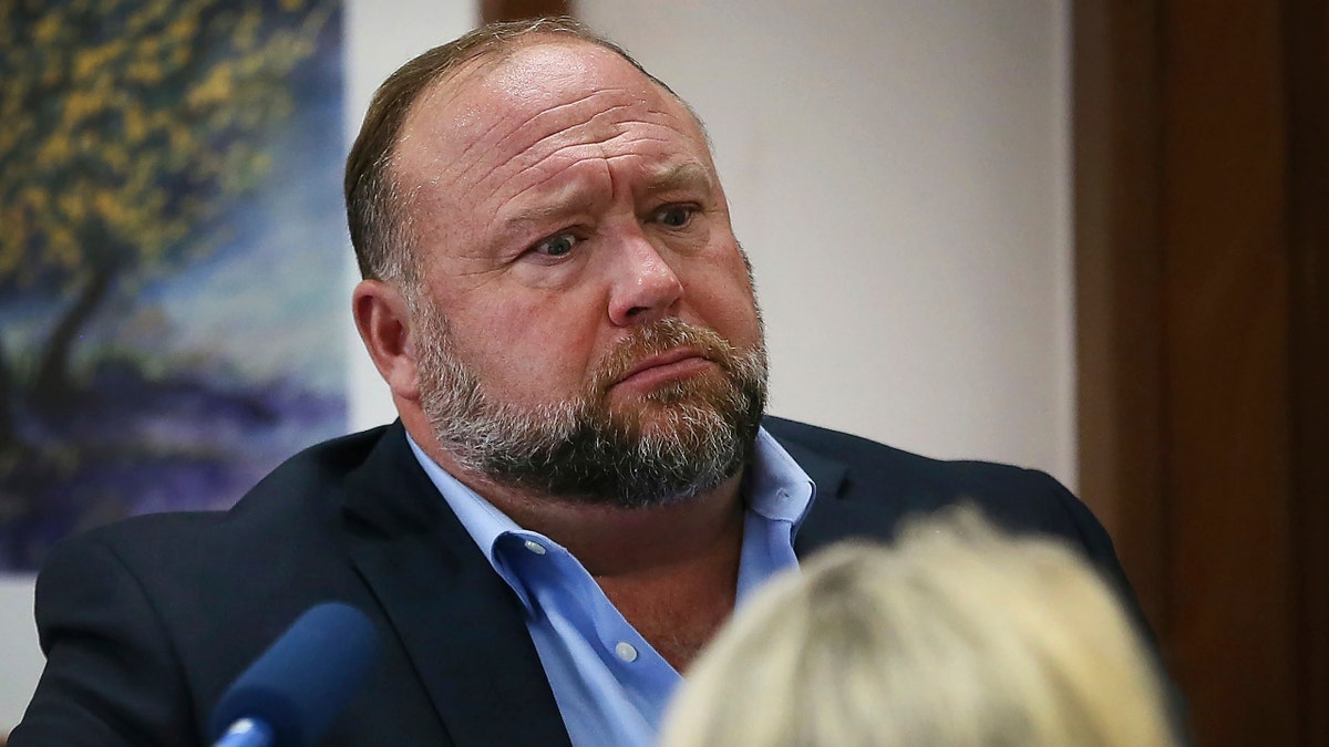Alex Jones attempts to answer questions about his emails during trial at the Travis County Courthouse in Austin