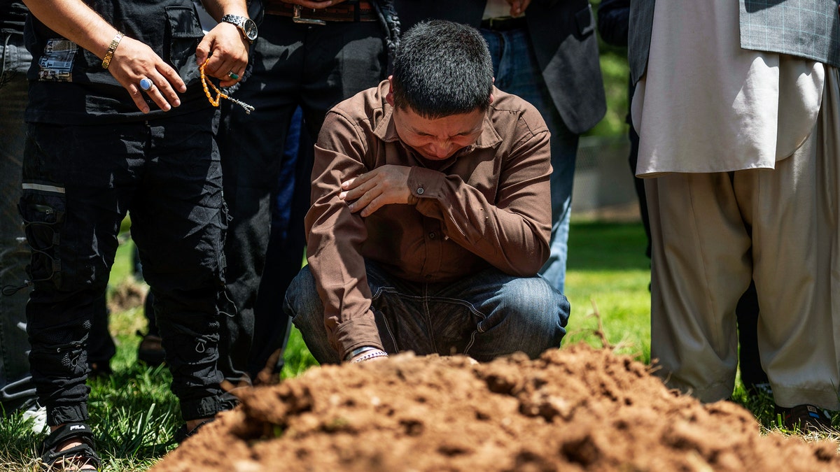 Man cries over grave of murdered brother