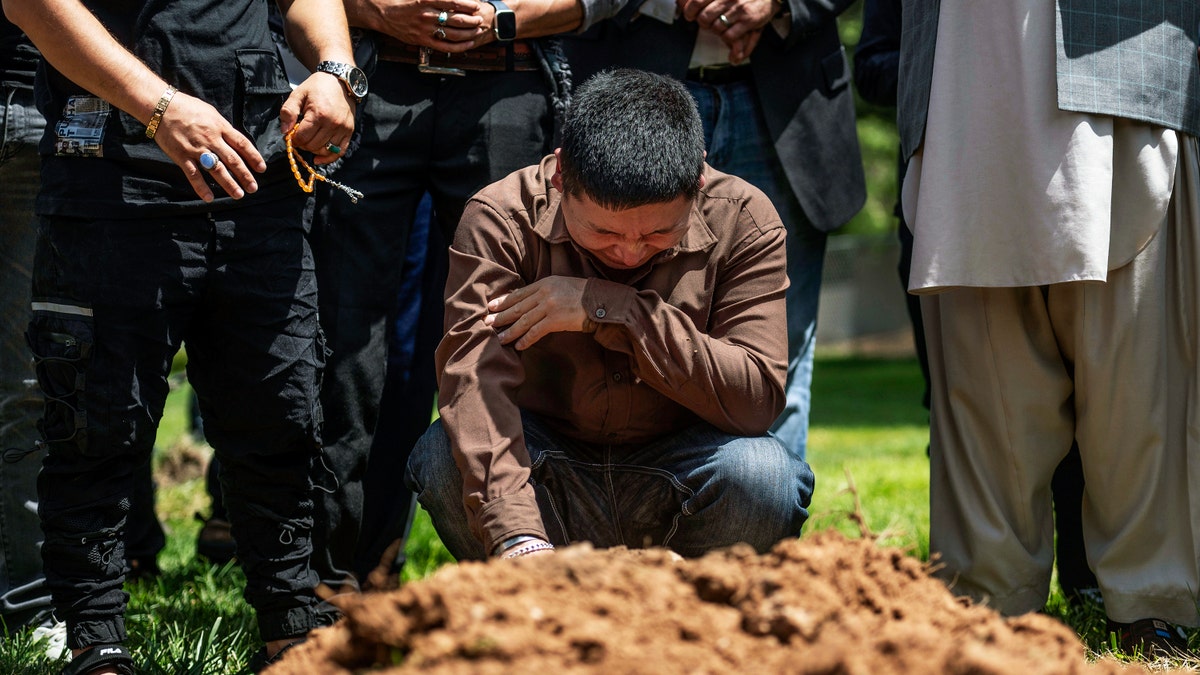 Man cries over grave of murdered brother