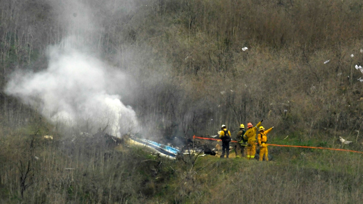 Firefighters work the scene of a the fatal Kobe Bryant helicopter crash