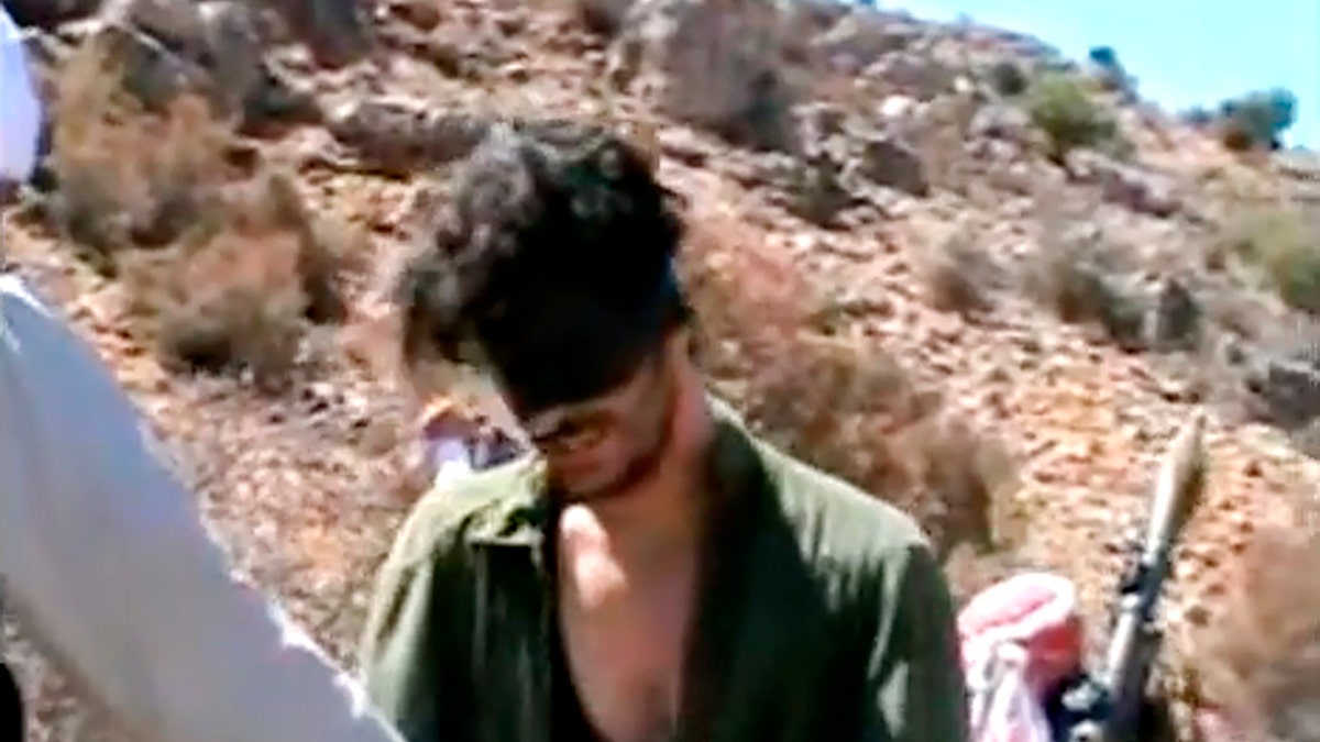 In this image taken from an undated video posted to YouTube, American freelance journalist Austin Tice, who had been reporting for American news organizations in Syria until his disappearance in August 2012, prays in Arabic and English while blindfolded in the presence of gunmen.