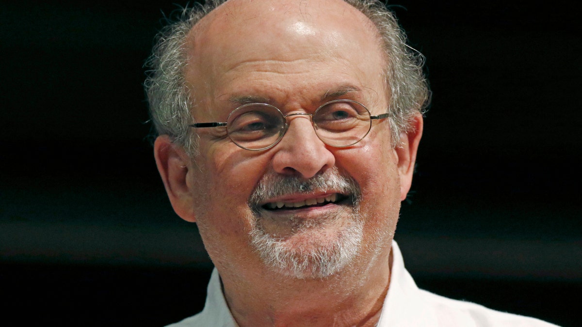 Salman Rushdie wearing white shirt at book signing