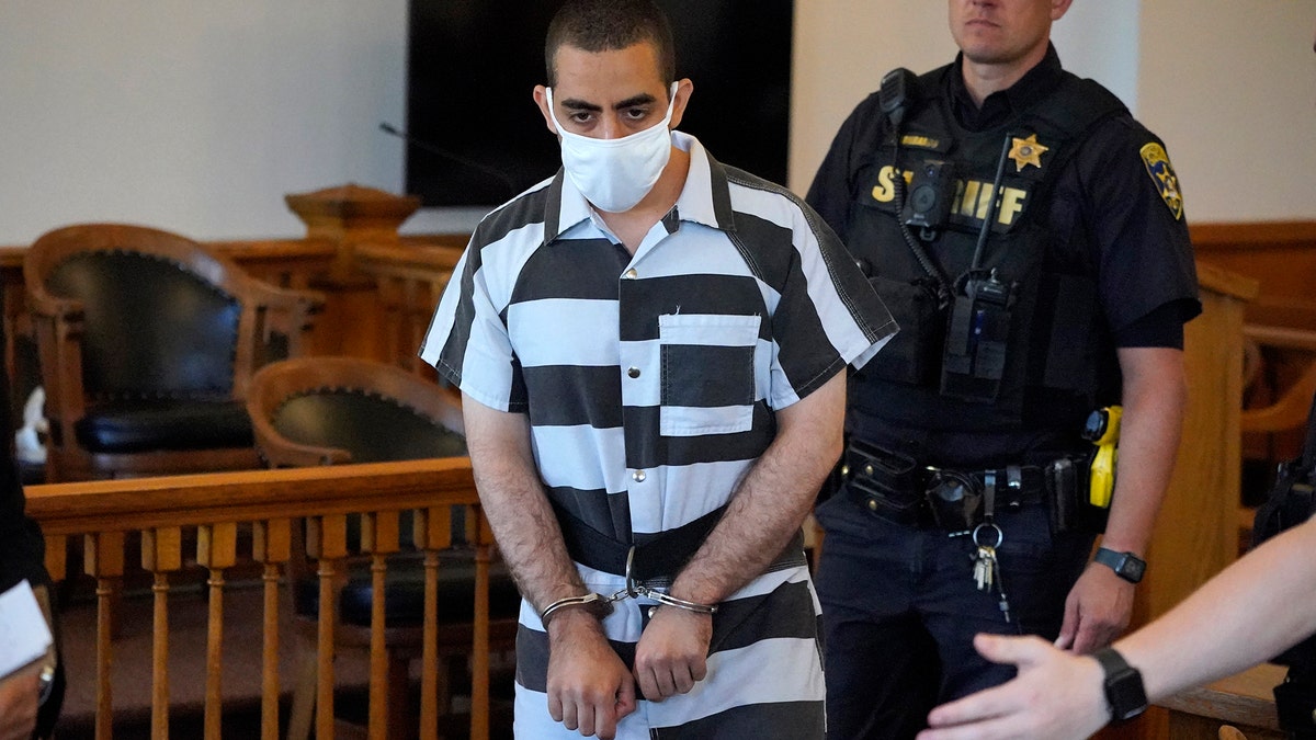 Hadi Matar, 24, center, arrives for an arraignment