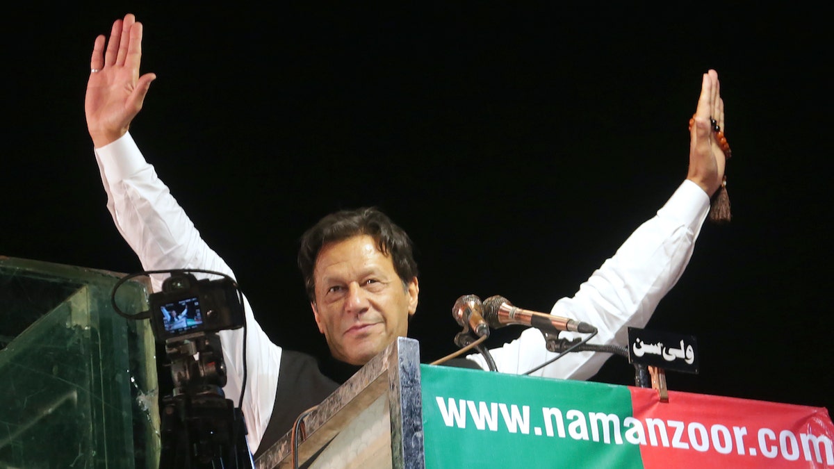 Imran Khan waving at a podium