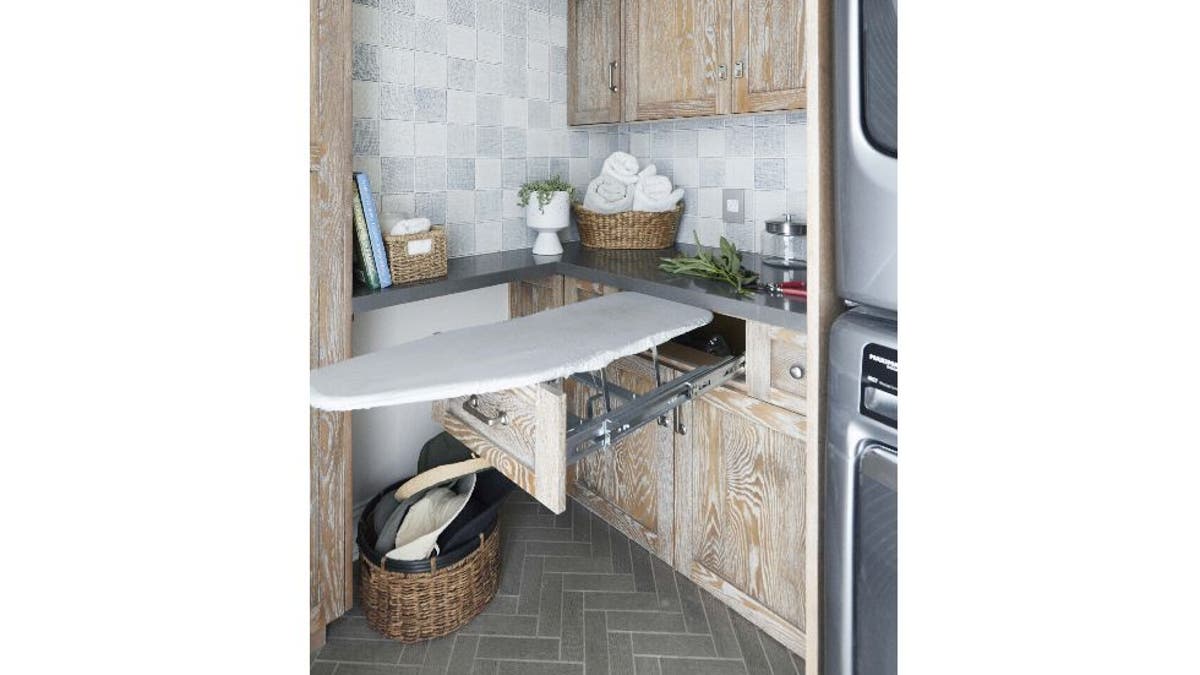 Laundry room with ironing board