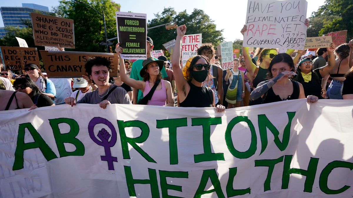 Demonstrators march and gather near the Texas state Capitol