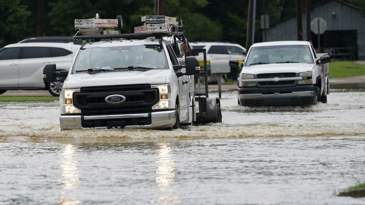 Pickup trucks in Mississippi floodwaters