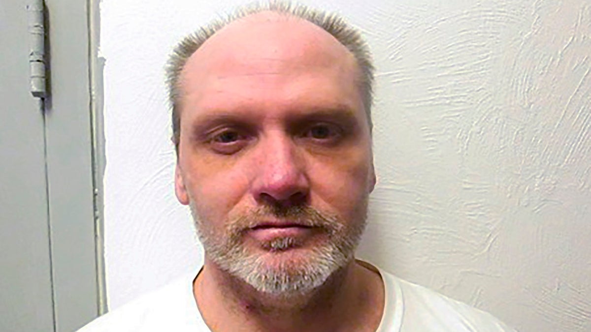 James Coddington wearing a white shirt in a booking photo