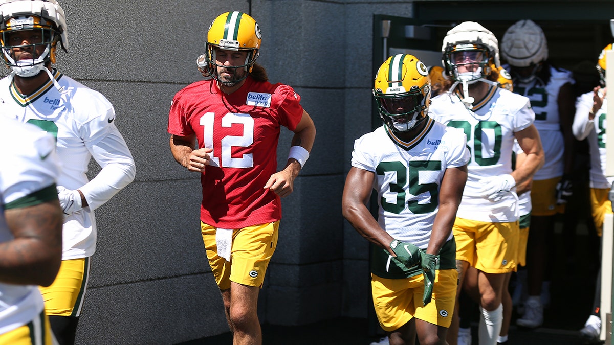 Aaron Rodgers walks with teammates