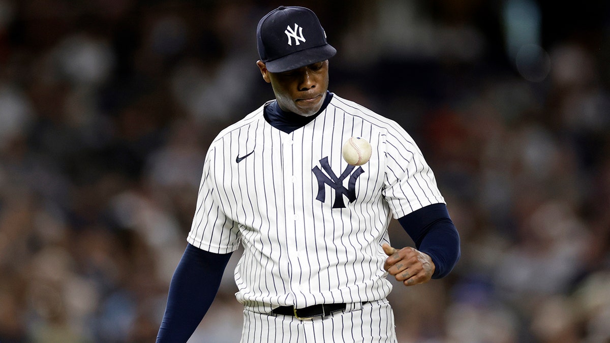 Yankees pitcher Aroldis Chapman tosses the ball