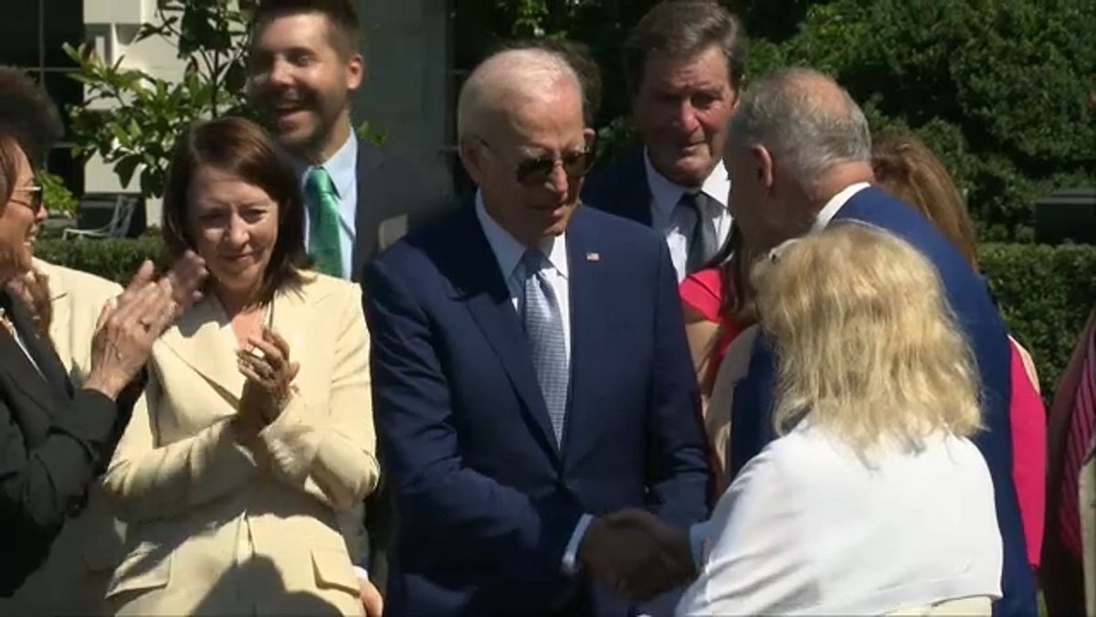 President Biden and Senate Majority Leader Chuck Schumer shake hands