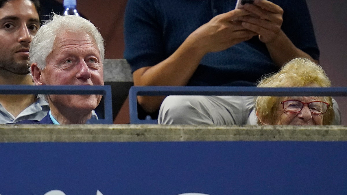 Bill Clinton and Ruth Westheimer sitting together at US Open