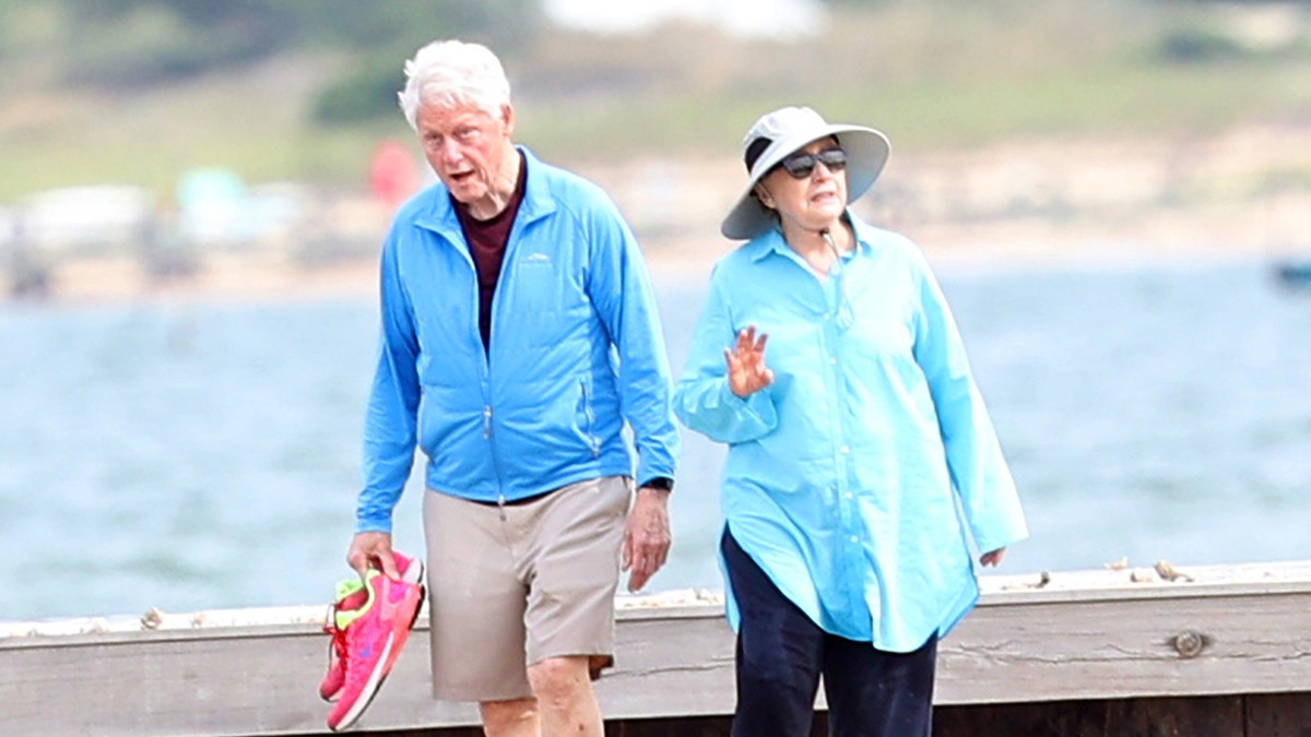 Bill and Hillary Clinton were photographed walking on the beach