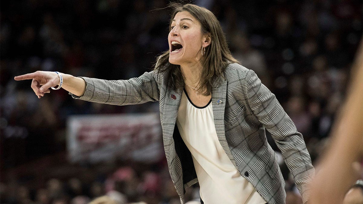 Brenda Mock Brown gestures to her team