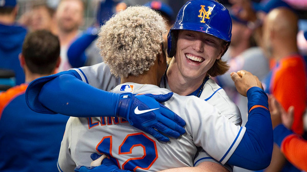 Brett Bay hugs Francisco Lindor