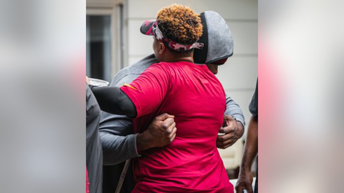 Brian Robinson Jr hugs coaches