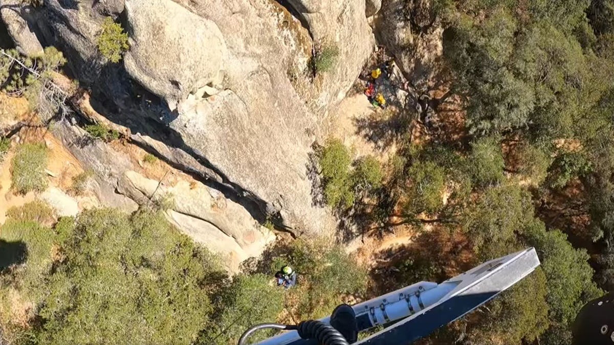 rescuers helping fallen climber