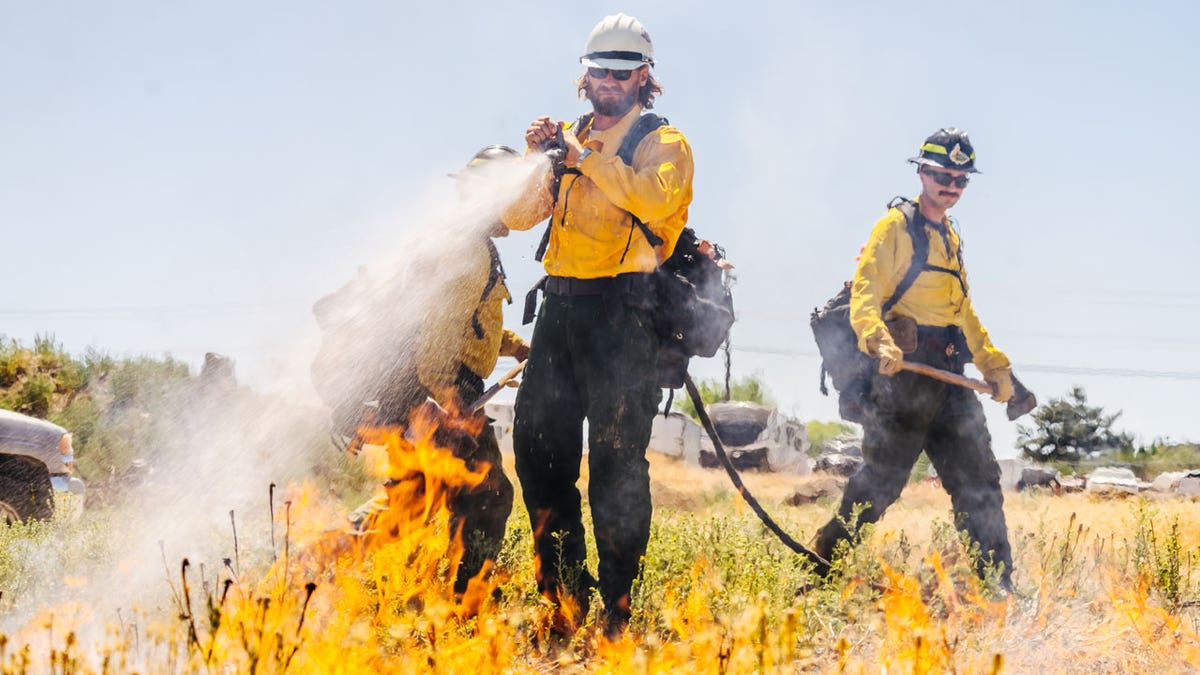 Chase Rice works with firefighters