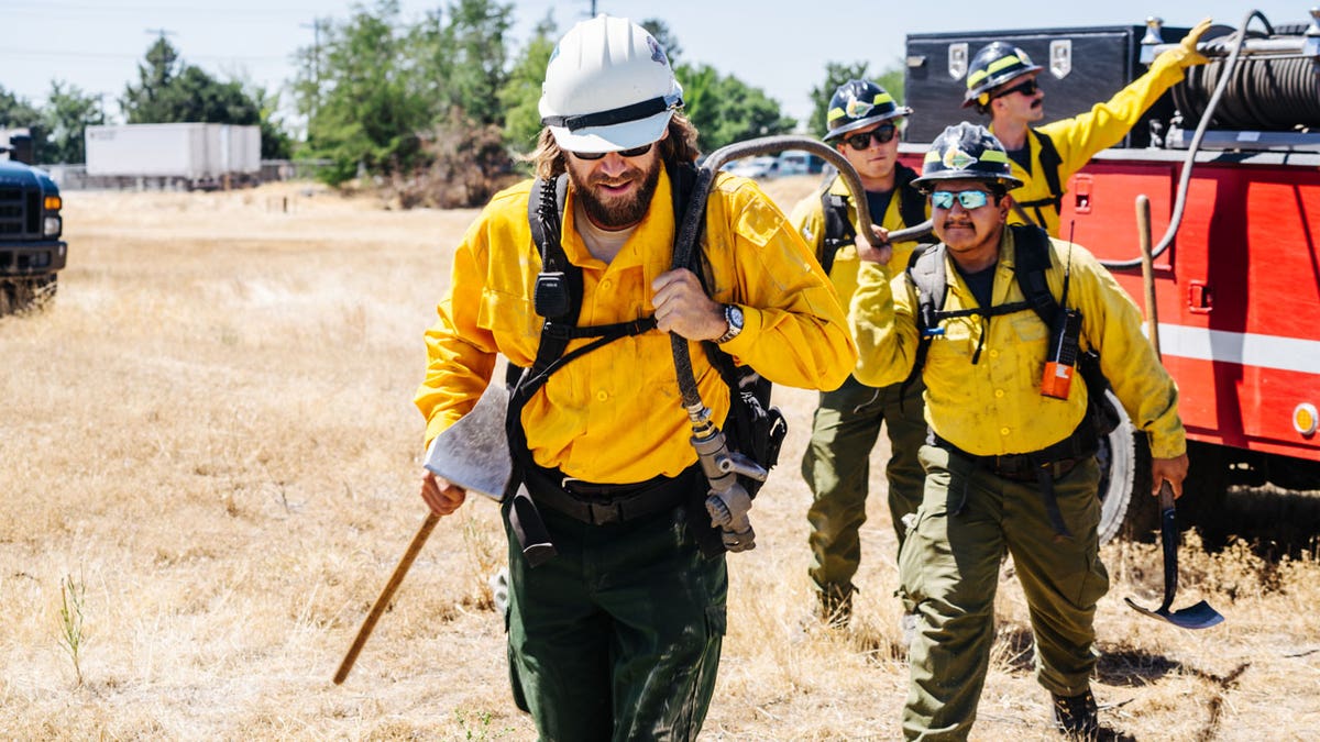 Chase Rice working with firefighters
