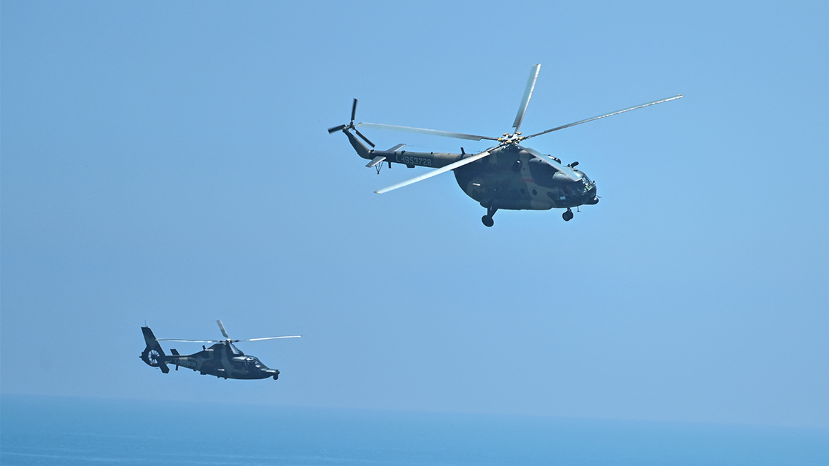 Chinese helicopters flying over the ocean
