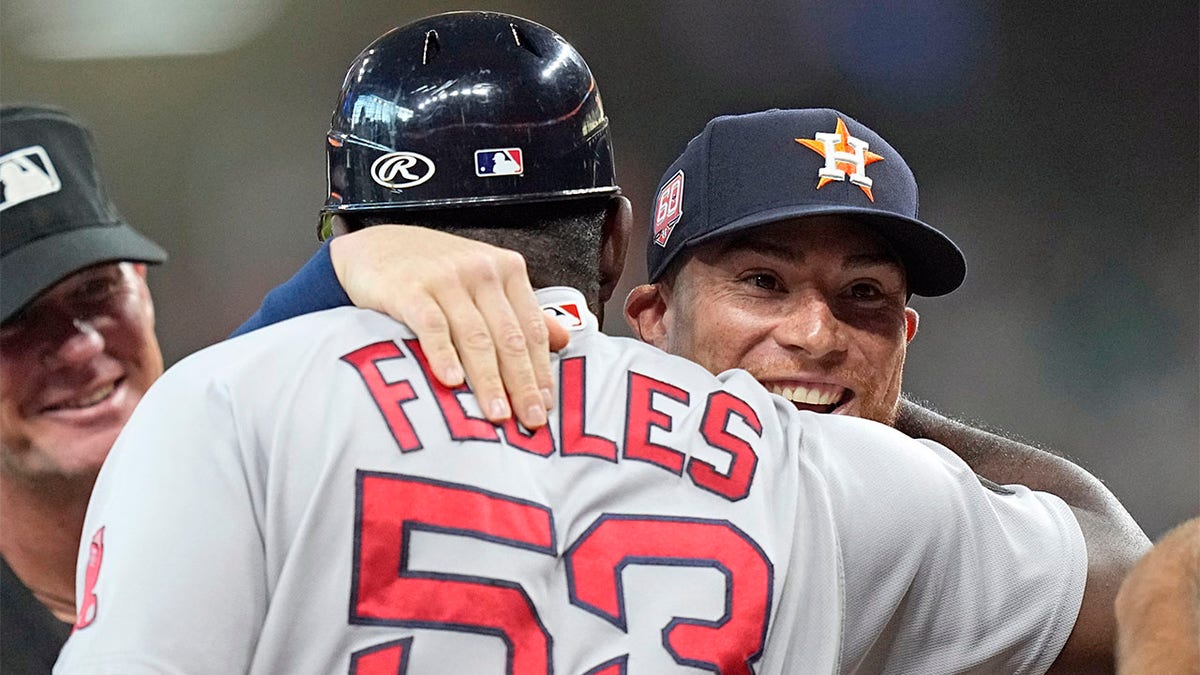 Christian Vazquez hugs Carlos Febles