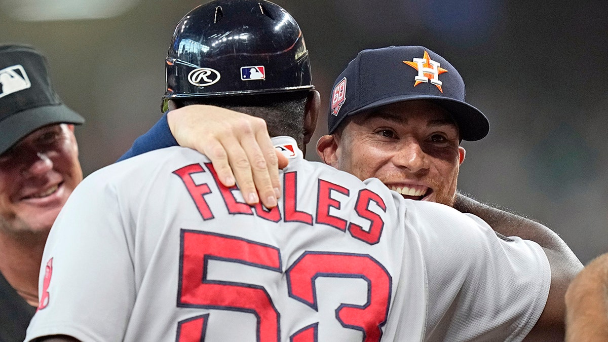 Christian Vazquez hugs Carlos Febles