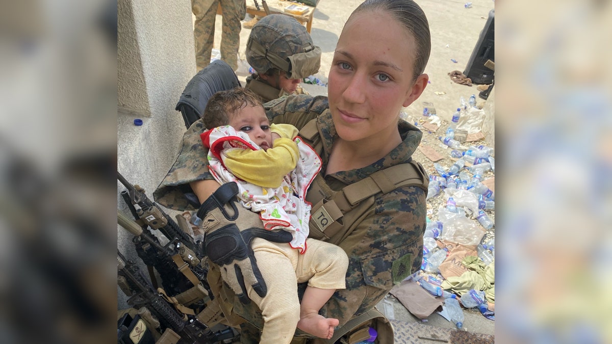 Sgt. Nicole Gee holds baby