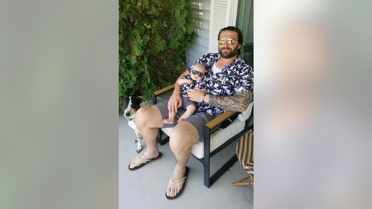 Dallas Edeburn holding a dog