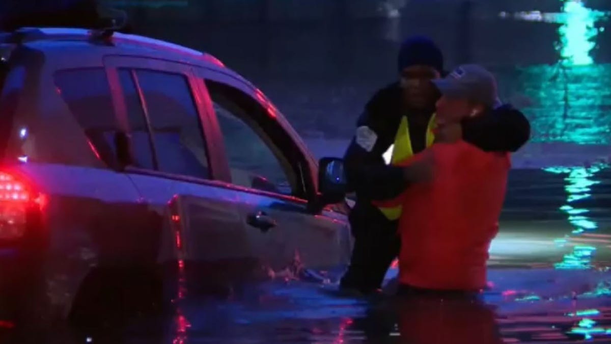 Robert Ray helping woman through car window