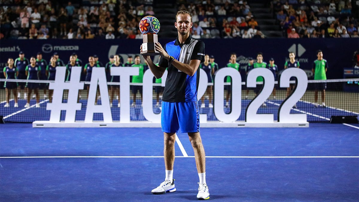 Daniil Medvedev holds trophy